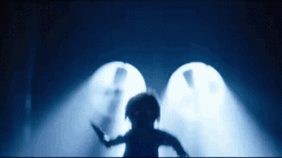 a silhouette of a person standing in a dark room