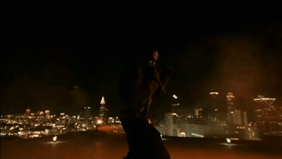 A Silhouette Of A Person Standing In A Dark Room With A Light On The Ground GIF