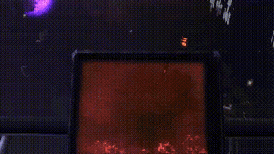 A Silhouette Of A Person Standing In A Dark Room With A Red Light Behind Them GIF