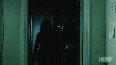 A Silhouette Of A Person Standing In A Dark Room With Hbo Written On The Wall GIF