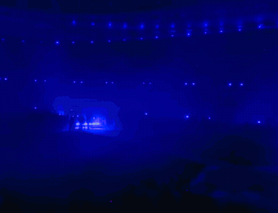 A Silhouette Of A Person Standing In Front Of A Blue And Purple Background GIF