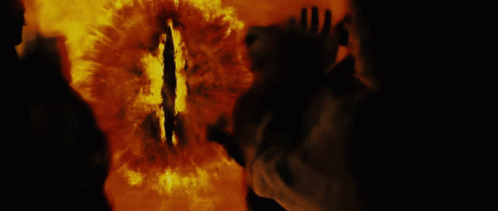 A Silhouette Of A Person Standing In Front Of A Fire With Smoke Coming Out Of Their Mouth GIF