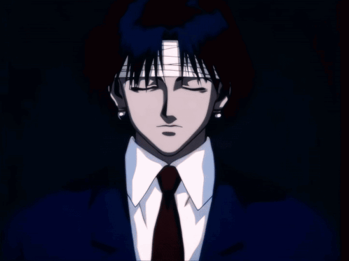 A Silhouette Of A Person Standing In Front Of A Window Looking Out At A City At Night GIF