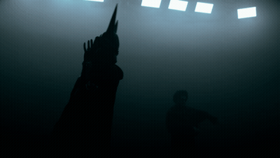 A Silhouette Of A Person Standing In The Dark GIF
