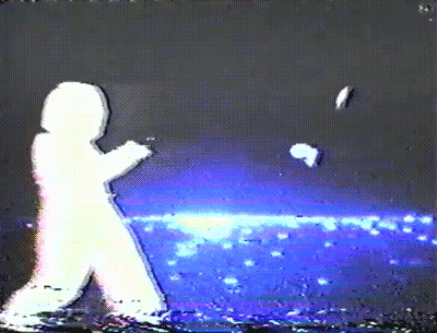 A Silhouette Of A Person Walking In The Dark With A Blue Background GIF