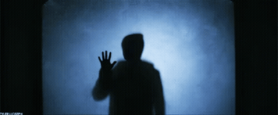 A Silhouette Of A Person Waving Their Hand In Front Of A Blue Background With The Letters Tb On It GIF