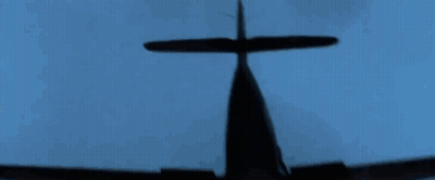 A Silhouette Of A Plane Flying In The Blue Sky GIF