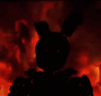 A Silhouette Of A Rabbit Is Standing In Front Of A Fire In The Dark . GIF