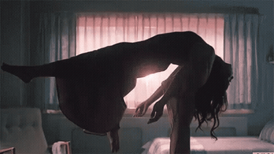 A Silhouette Of A Woman Floating In The Air With A Window Behind Her GIF