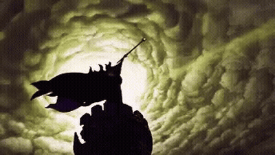 A Silhouette Of Batman Flying Through A Cloudy Sky GIF