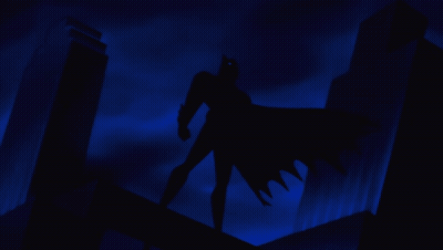A Silhouette Of Batman Standing On A Building Roof GIF