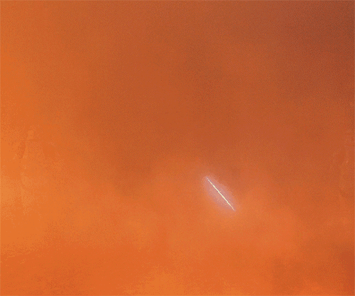 A Silhouette Of Darth Vader Is Standing In Front Of A Fire GIF