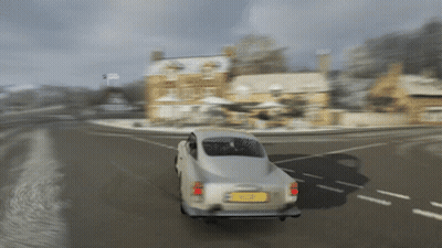 A Silver Car Is Driving Down A Snowy Road With A Yellow License Plate Which Says ' A ' On It GIF