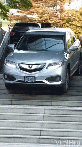 A Silver Car Is Parked On A Set Of Stairs And Says Viralhog On The Bottom Left GIF