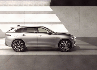 A Silver Car Is Parked On A Tiled Floor In Front Of A Wall GIF