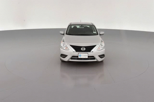 A Silver Car Sits On A Gray Surface GIF