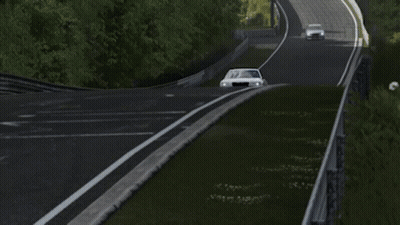 A Silver Chrysler Car Is Driving Down A Track GIF