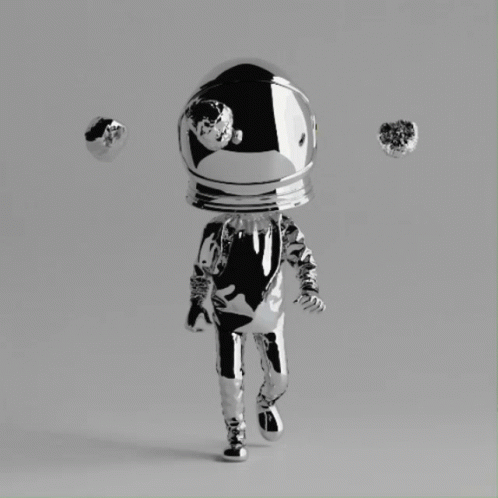 A Silver Figurine Of An Astronaut With A Helmet On GIF