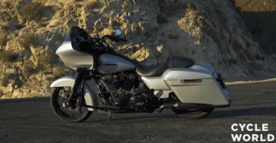 A Silver Harley Davidson Motorcycle Is Parked On A Road GIF