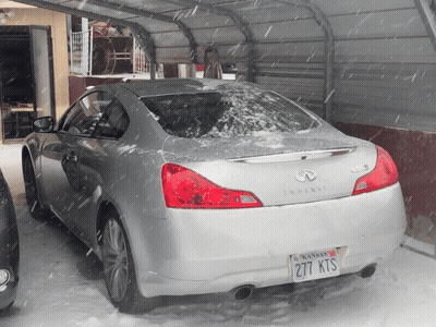 A Silver Infiniti Is Parked In The Snow And Has A Kansas License Plate GIF