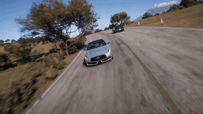 A Silver Infiniti Sports Car Is Driving Down A Road GIF