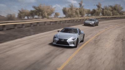 A Silver Lexus Is Driving Down A Road Next To A Silver Car GIF