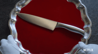 A Silver Plate With A Knife On It And A Netflix Logo In The Corner GIF