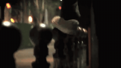 A Skateboarder Is Doing A Trick In Front Of A Bridge GIF