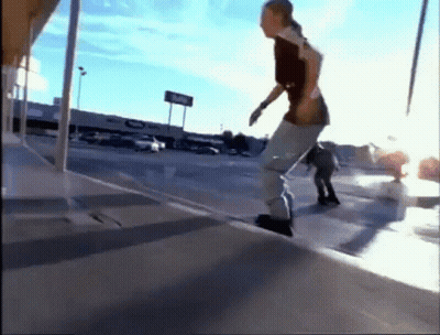 A Skateboarder Is Doing A Trick On A Sidewalk In Front Of A Store That Says Coke GIF