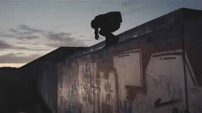 A Skateboarder Is Doing A Trick On Top Of A Wall That Has Graffiti On It Including The Letters Sb GIF