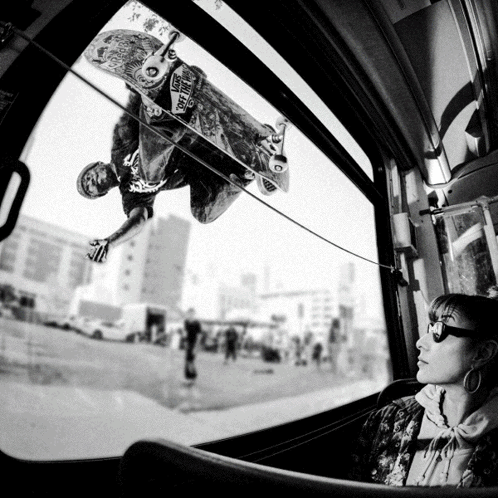 A Skateboarder Is Doing A Trick While Wearing A Shirt That Says Vans On The Front GIF