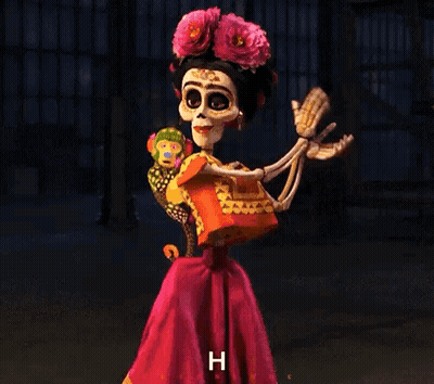 A Skeleton Dressed As Frida Kahlo Is Holding A Stuffed Animal And Giving A Thumbs Up . GIF