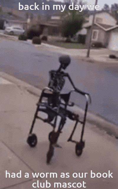 A Skeleton In A Walker With The Words Back In My Day We Had A Worm As Our Book Club Mascot GIF