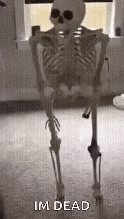 A Skeleton Is Standing In A Room With The Words `` Im Dead '' Written On It . GIF