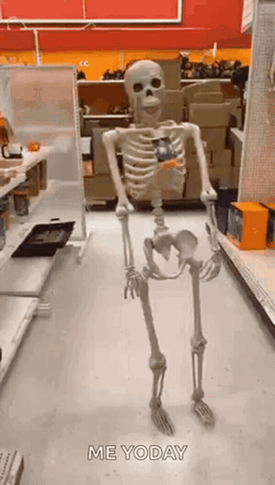 A Skeleton Is Standing In A Store Holding A Candy Bar . GIF