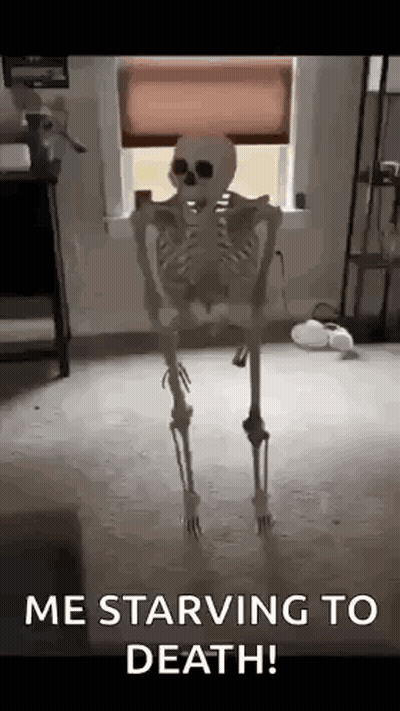 A Skeleton Is Standing In Front Of A Window With The Words `` Me Starving To Death '' Written On It . GIF