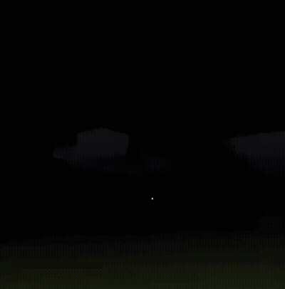 A Skeleton Is Standing On A Grassy Hill In A Dark Video Game . GIF