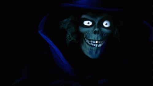 A Skeleton With Glowing Eyes And A Blue Top Hat GIF