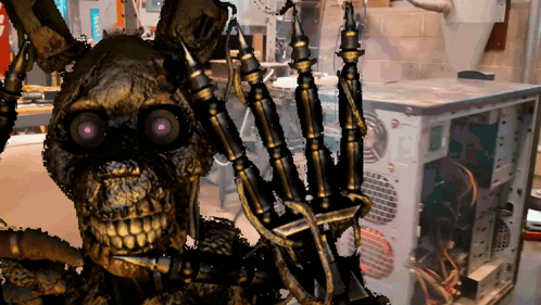 A Skeleton With Purple Eyes Is Standing In Front Of A Computer Monitor GIF