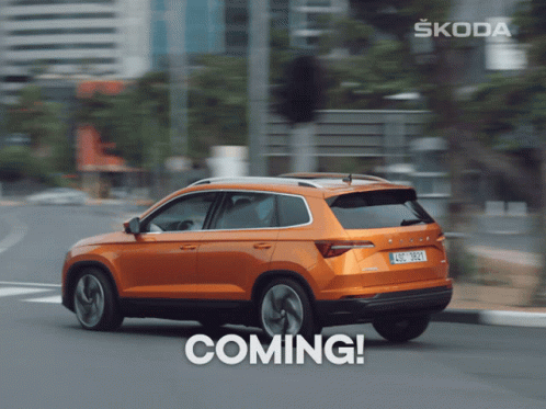A Skoda Car Is Driving Down A Street With The Word Coming Below It GIF