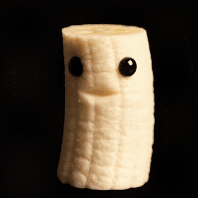 A Slice Of Banana With A Face On It And Black Eyes GIF