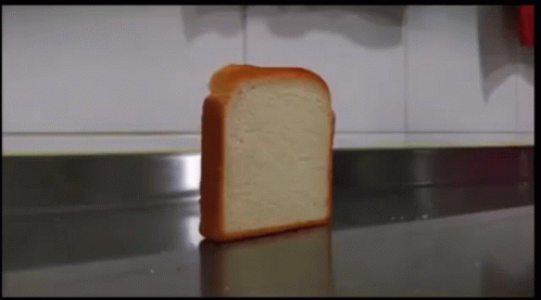 A Slice Of Bread Is Sitting On A Counter In A Kitchen . GIF
