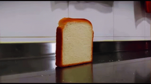 A Slice Of Bread Is Sitting On A Countertop GIF