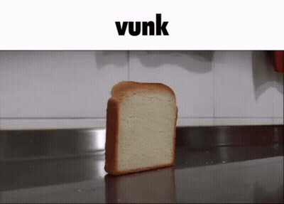 A Slice Of Bread Sits On A Counter Under A Banner That Says Vunk GIF