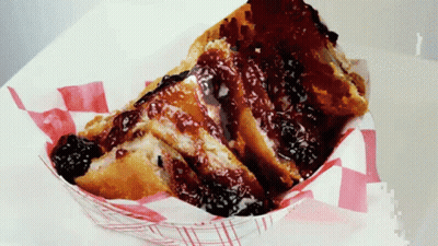 A Slice Of French Toast With A Berry Sauce On Top GIF