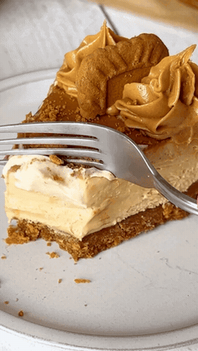 A Slice Of Peanut Butter Pie On A Plate With A Fork In It GIF