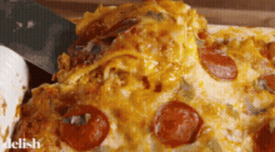 A Slice Of Pepperoni Pizza Is Being Taken Out Of A Casserole Dish GIF