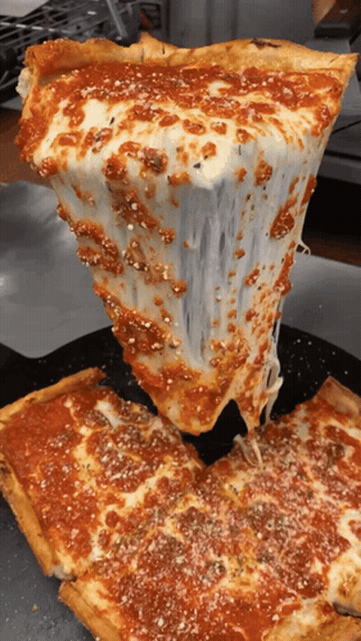 A Slice Of Pizza Is Being Taken Out Of The Pizza GIF
