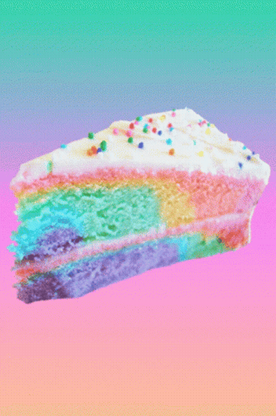 A Slice Of Rainbow Cake With Sprinkles On Top GIF