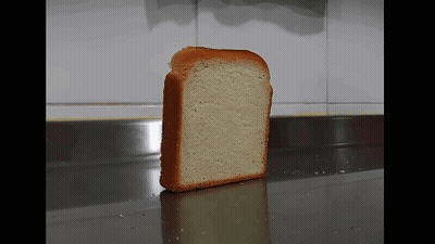 A Slice Of White Bread Is Sitting On A Counter GIF
